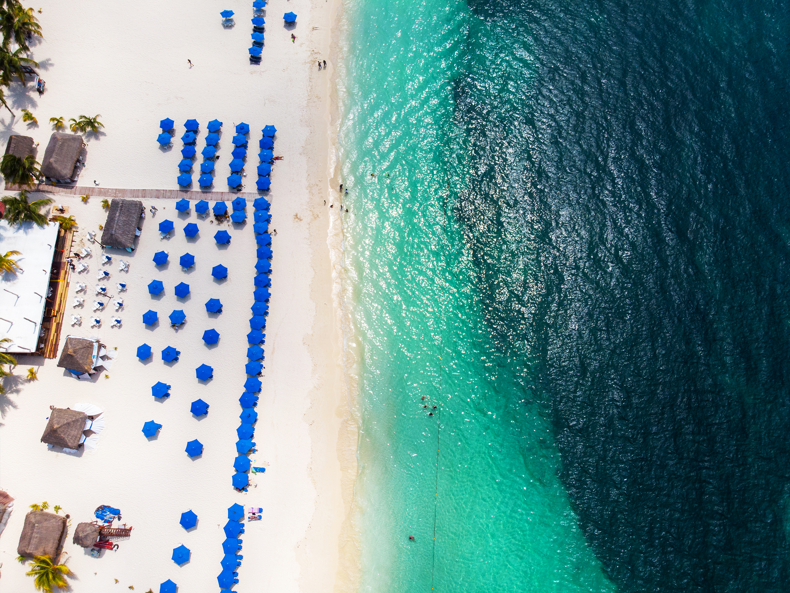 Aerial view of the beach with hammocks and umbrellas