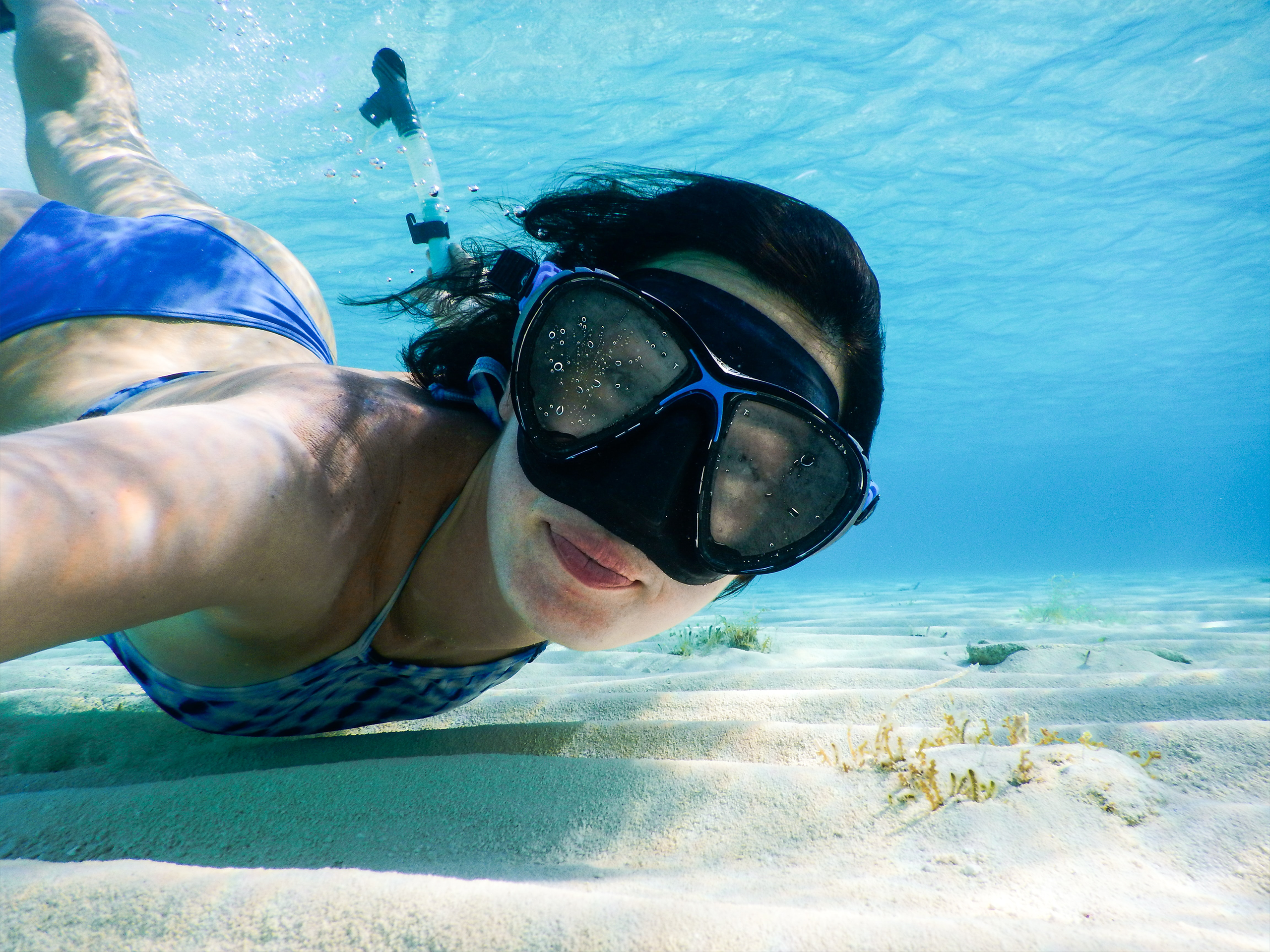 Mujer realizando snorkel en las aguas del mar caribe en Isla Mujeres