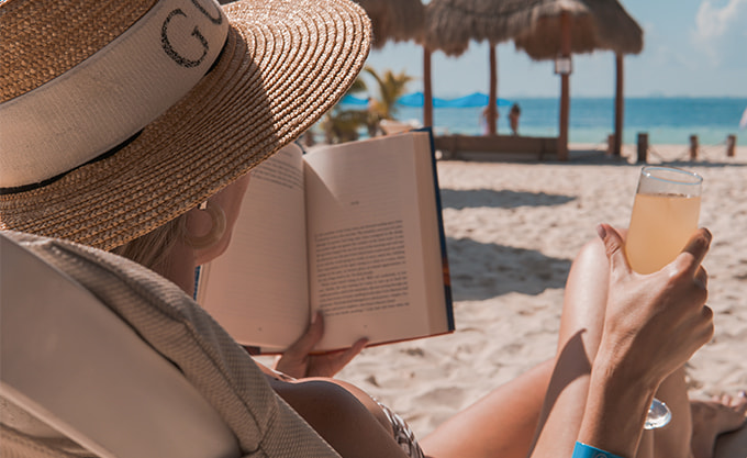 Woman reading a book in front of Playa Norte