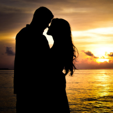 Novios en actitud romántica en la playa de  Isla Mujeres