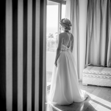 Bride looking out the window from the hotel suite
