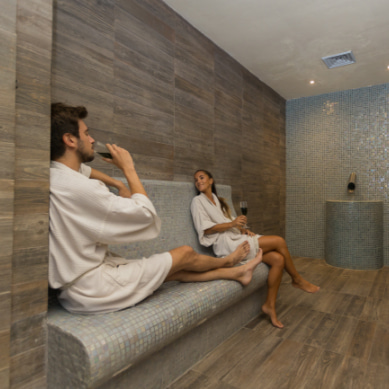 Couple enjoying a glass of champagne at the spa