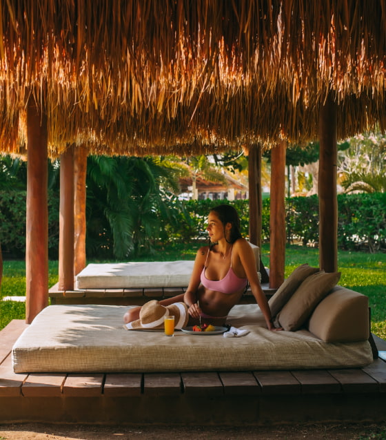 Woman reading a book in bed Balinese