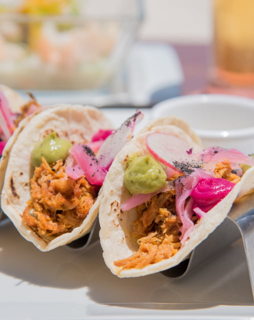 Mexican tacos Beef taco with onion and guacamole served at Playa Norte Beach Club