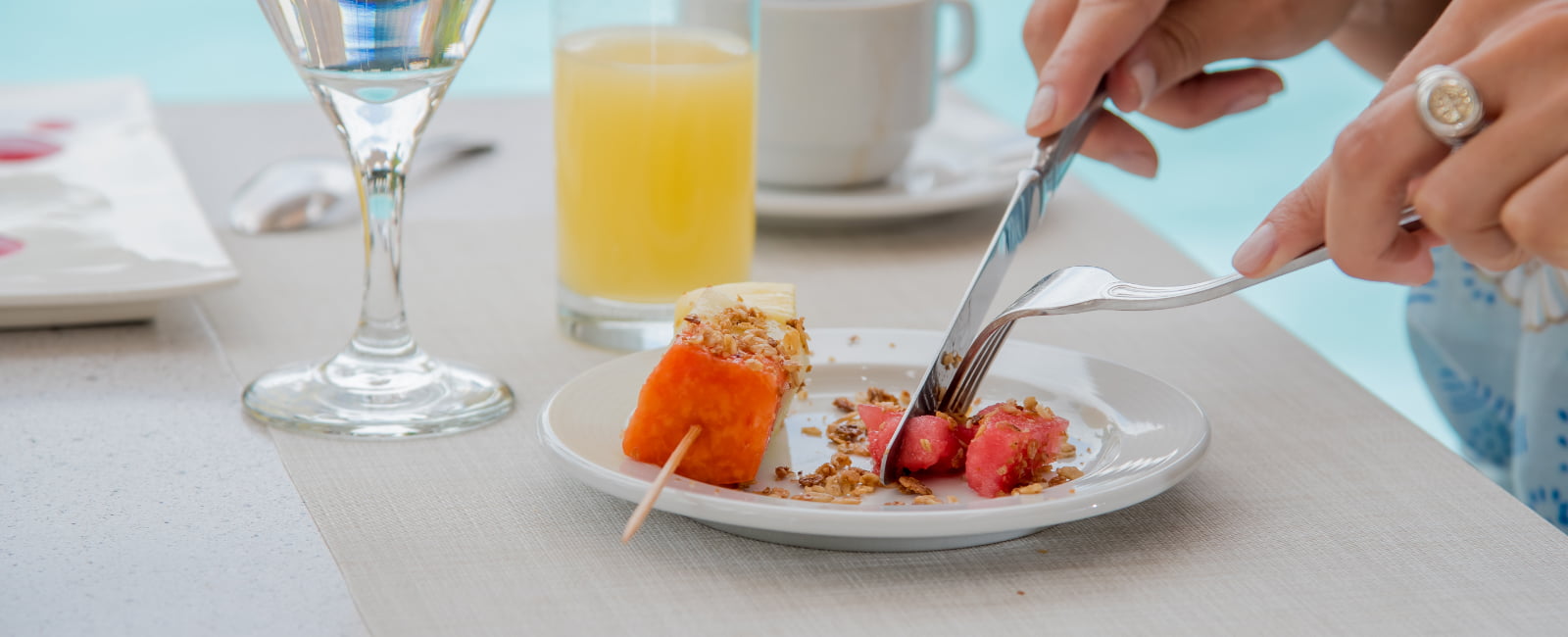 Woman eating fruit and juice for breakfast