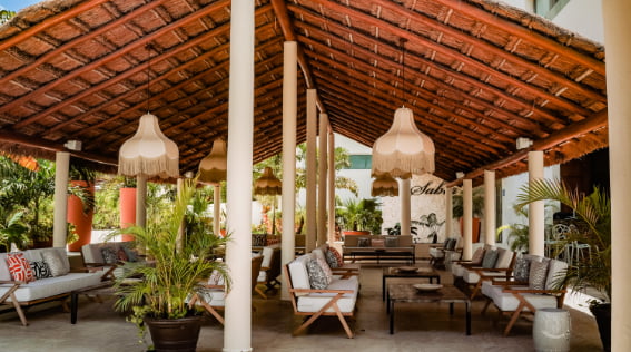 Tables and armchairs in a pergola