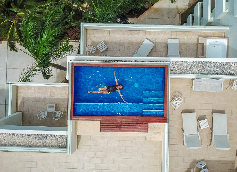 Woman enjoying the private pool of the Presidential Suite