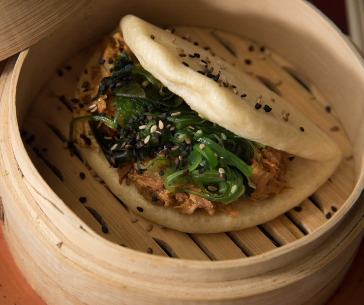 Meat and vegetable bao served