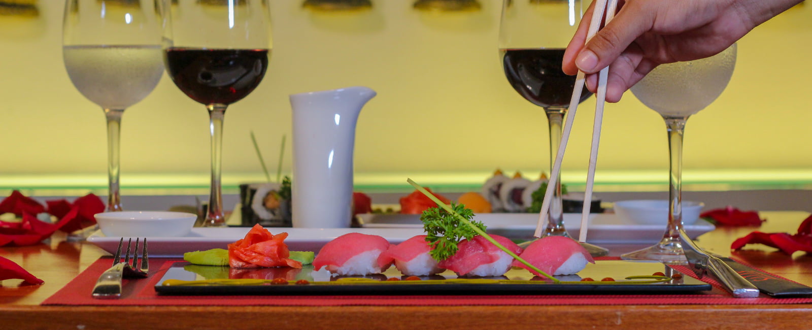 Woman eating Nigiri with Wine with chopsticks