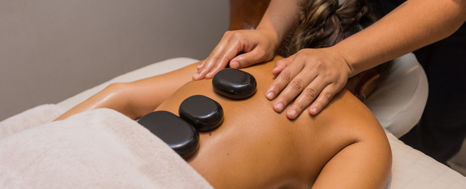 Woman with Spa stones on her back